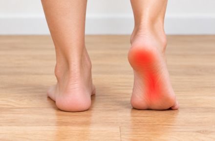 Bare heel with the arch and heel highlighted red to show plantar fasciitis pain